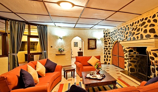 Amboseli Sopa Lodge nestled in lush gardens, offering comfortable safari accommodation near Amboseli National Park with Cruzeiro Safaris Kenya.